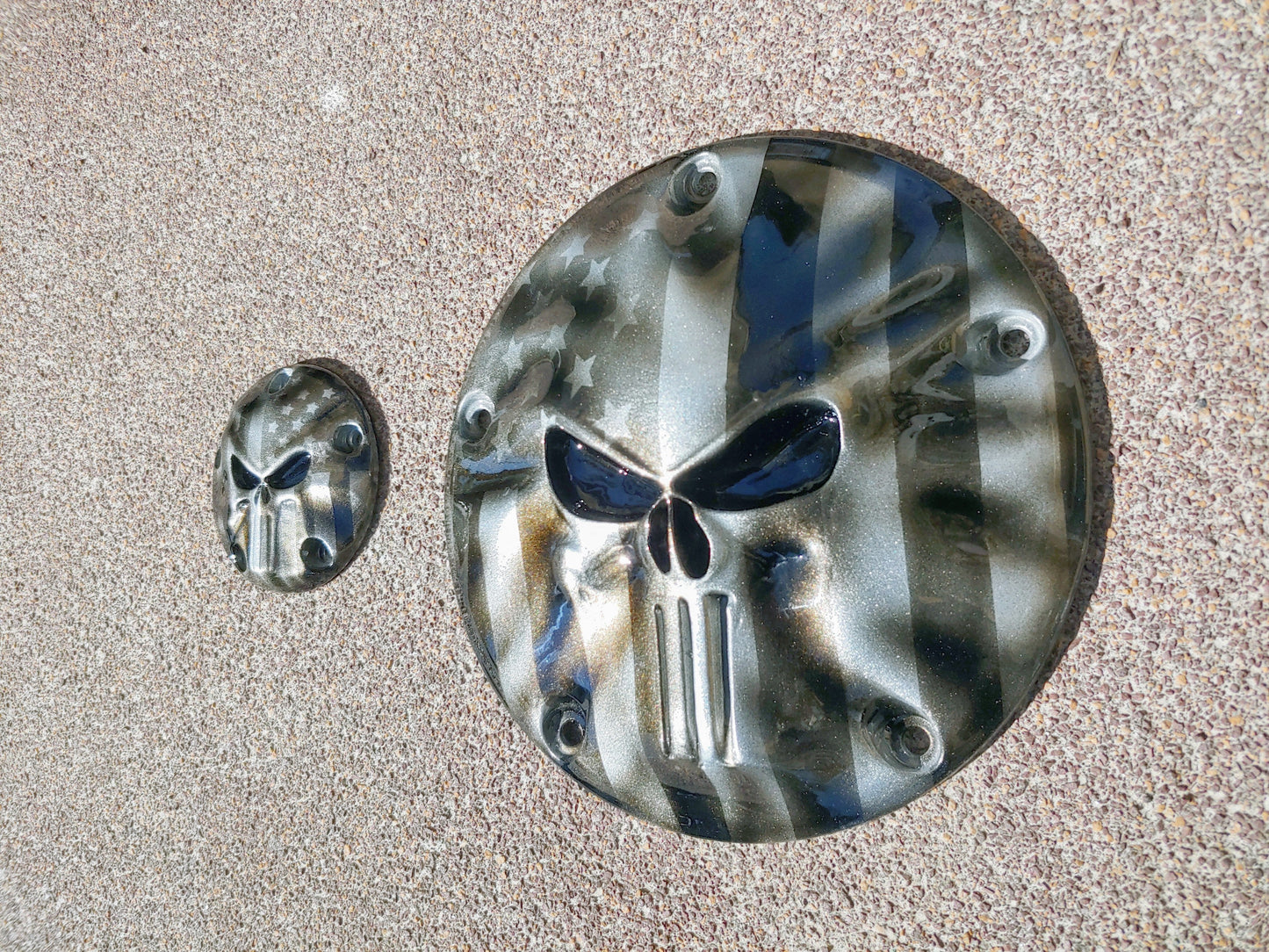 Punisher stretching through black and silver Flag Harley derby and points cover