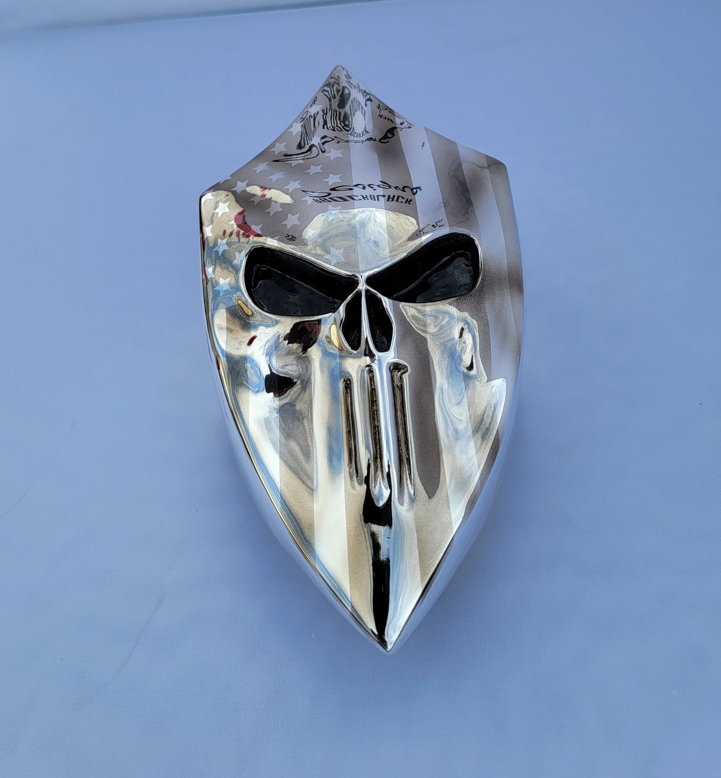 Chrome Harley horn cover with punisher stretching through