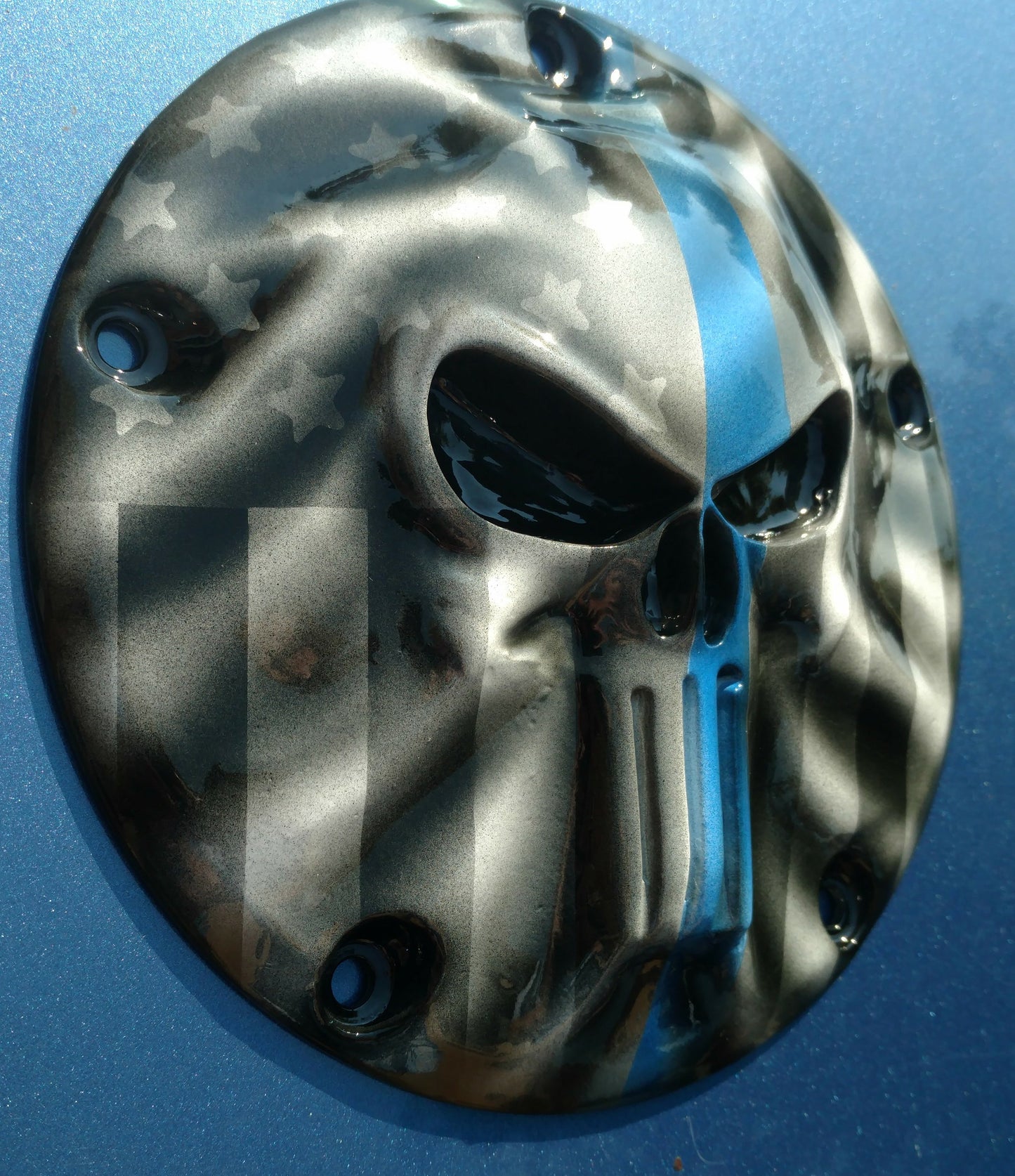 Punisher stretching through Thin Blue Line Flag Harley derby cover