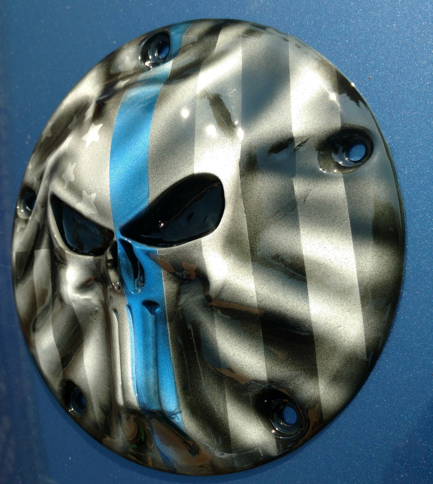 Punisher stretching through Thin Blue Line Flag Harley derby cover