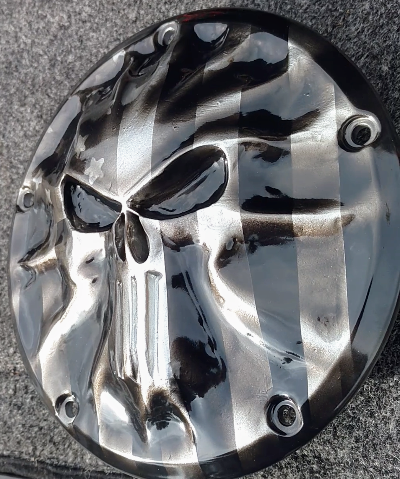 Punisher stretching through black and silver Flag Harley derby cover