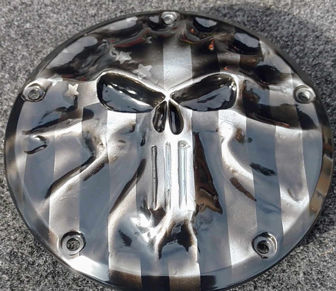 Punisher stretching through black and silver Flag Harley derby cover