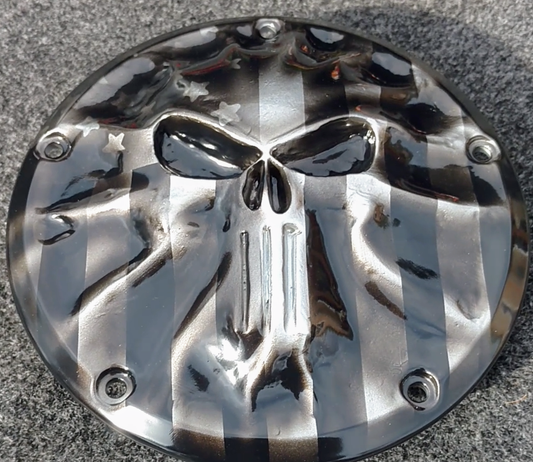 Punisher stretching through black and silver Flag Harley derby cover